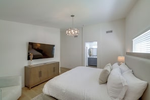 A bedroom with a bed, a television, a cabinet, and a window with blinds. - Coachella Getaway w/ Yard! Near Festivals & Golf (Coachella)