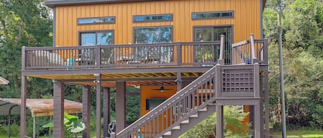 A two-story wooden building with a balcony and a staircase.