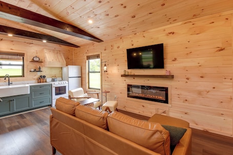 A cozy cabin interior with a kitchen, dining area, and living room.
