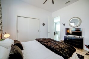 A bedroom with a bed, a dresser, a mirror, and a television. - Community Boat Ramp! Family Escape w/ Fenced Yard (Granbury)