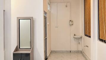 Un baño moderno con tocador, espejo, lavamanos y ventilador de techo.