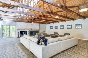 A spacious living room with a large sectional sofa, a fireplace, and a wooden ceiling structure. - Breckenridge Ski Condo: Easy Bus to Slopes (Breckenridge)