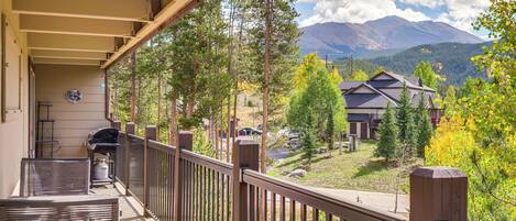 A balcony with a view of a mountain range and a residential area.