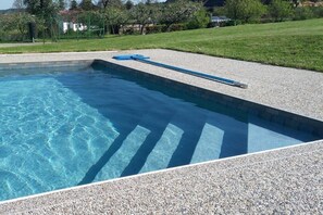 A swimming pool with a pebble deck and a blue pool ladder. - ||---------------------Valahof Barn----------------------|| (Milevsko)
