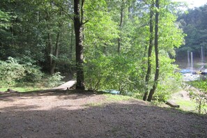 A forested area with a dirt path leading to a dock by a body of water. - ||---------------------Valahof Barn----------------------|| (Milevsko)