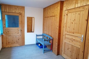 A room with wooden doors, a bench, and a small blue storage unit. - ||--------------under the linden tree----------------|| (Quitzdorf\/ OT Steinölsa)
