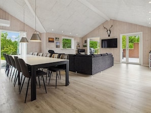 A spacious living area with a dining table, sofas, and a TV mounted on the wall. - "Ellin" - 3.3km from the sea by Interhome (Rømø)