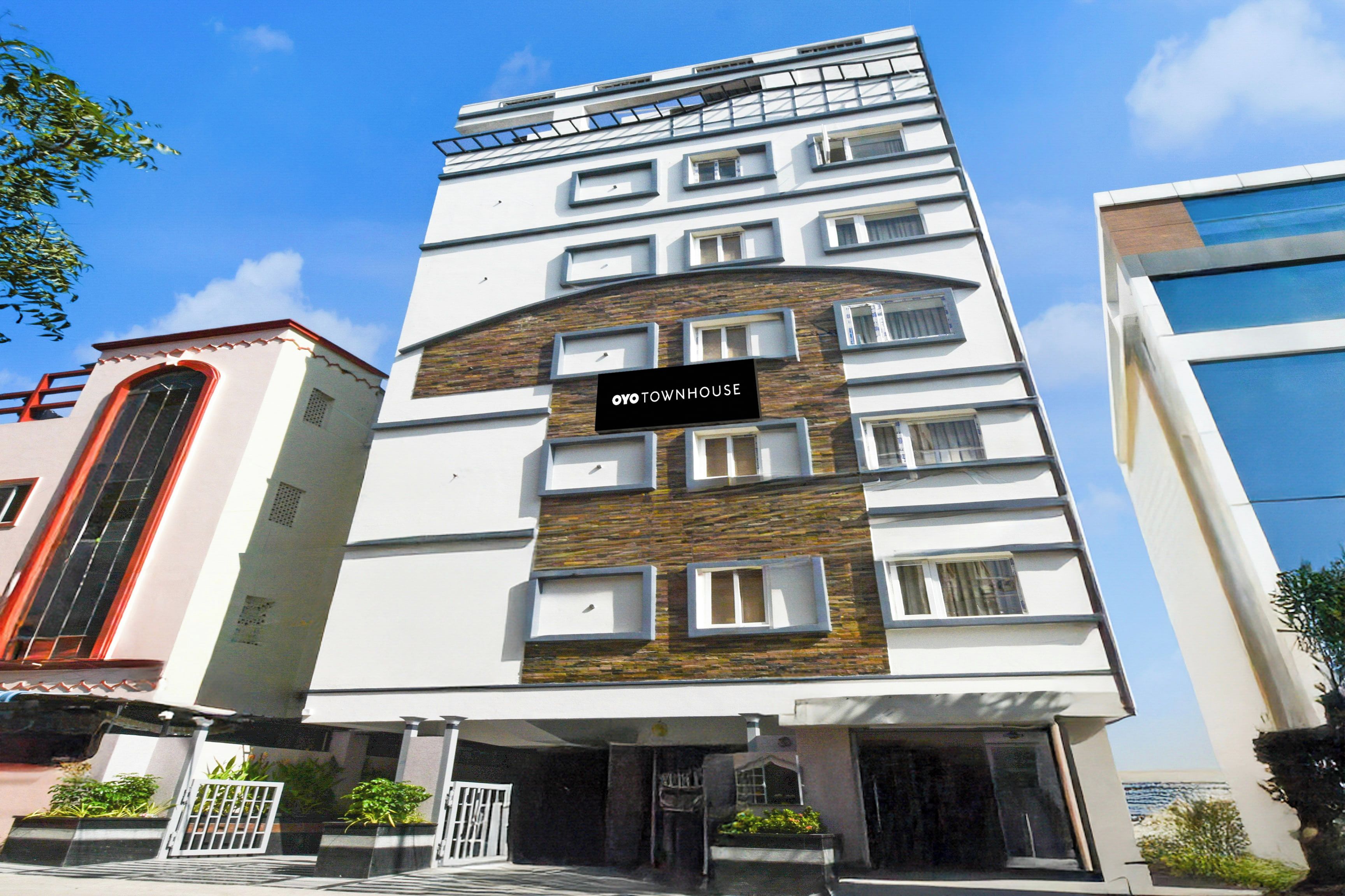 A multi-story building with a sign reading 'OYO TOWNHOUSE'.