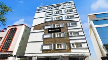 A multi-story building with a sign reading 'OYO TOWNHOUSE'.