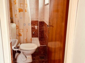 A bathroom with a toilet, bidet, and shower curtain. - Apartments Adriana Studio Apartment 6 (Gradac)