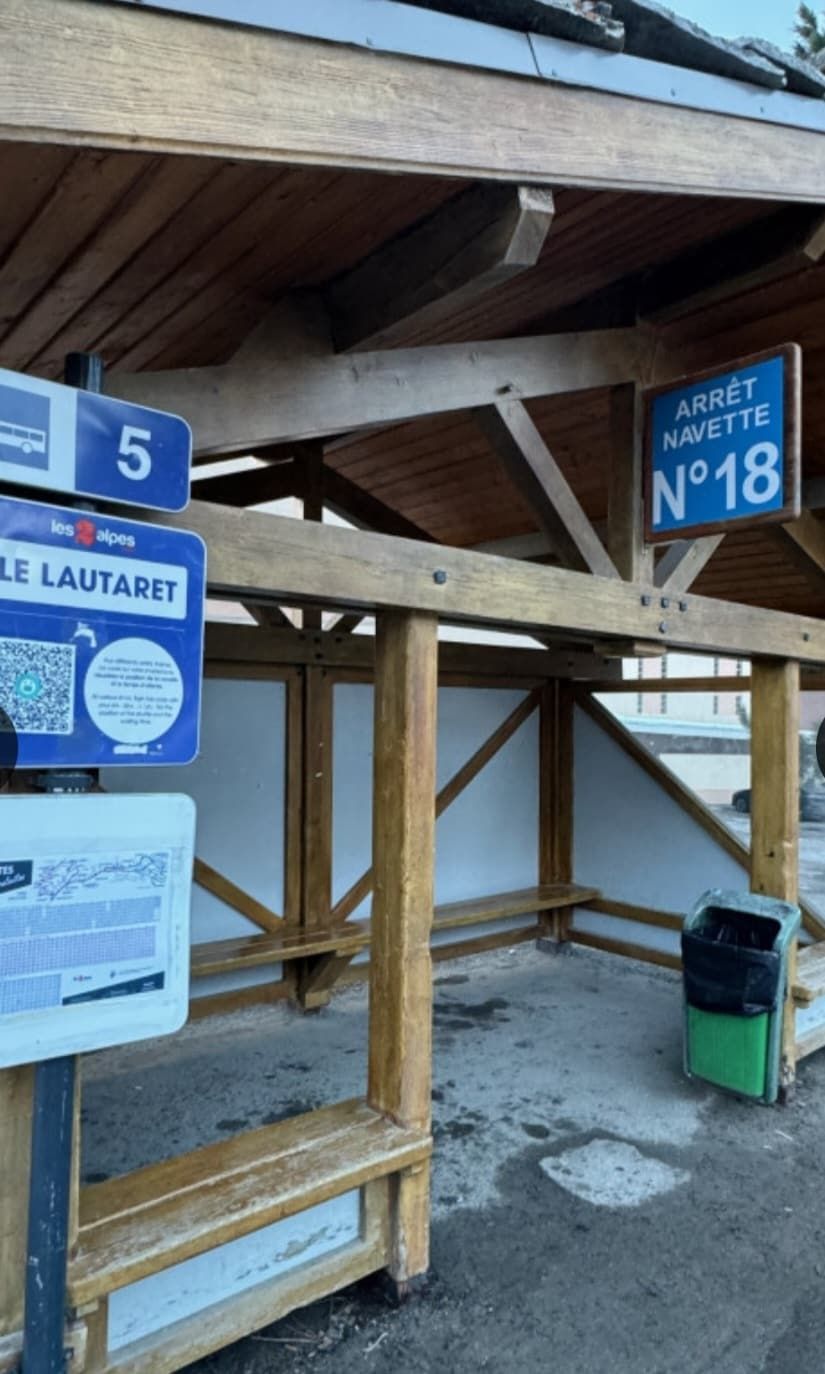 A wooden structure with signs indicating a parking area and a location number.
