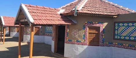 A row of traditional buildings with tiled roofs and colorful mosaic decorations.