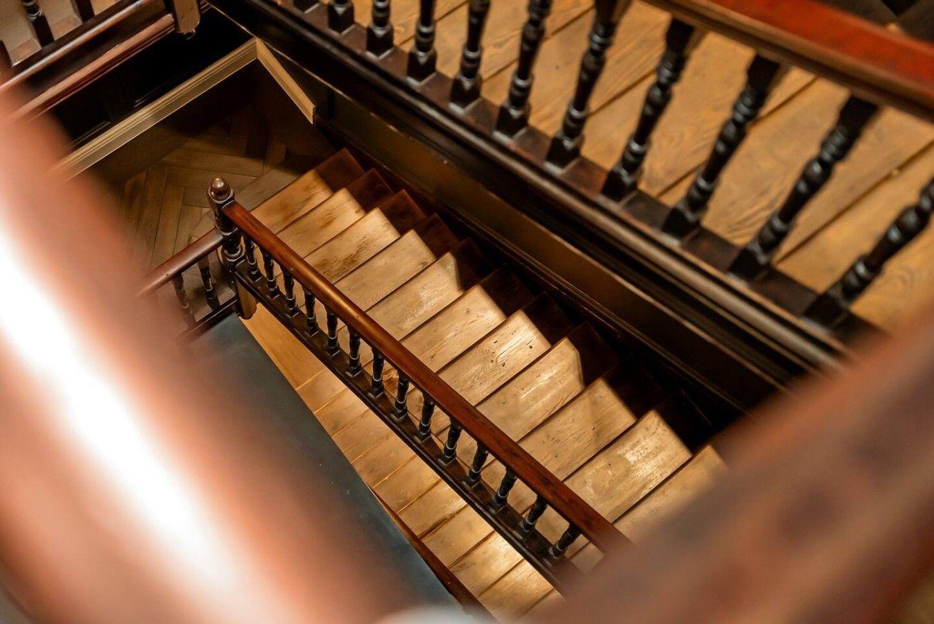 A staircase with wooden steps and a metal railing.