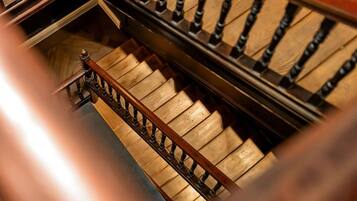 A staircase with wooden steps and a metal railing.