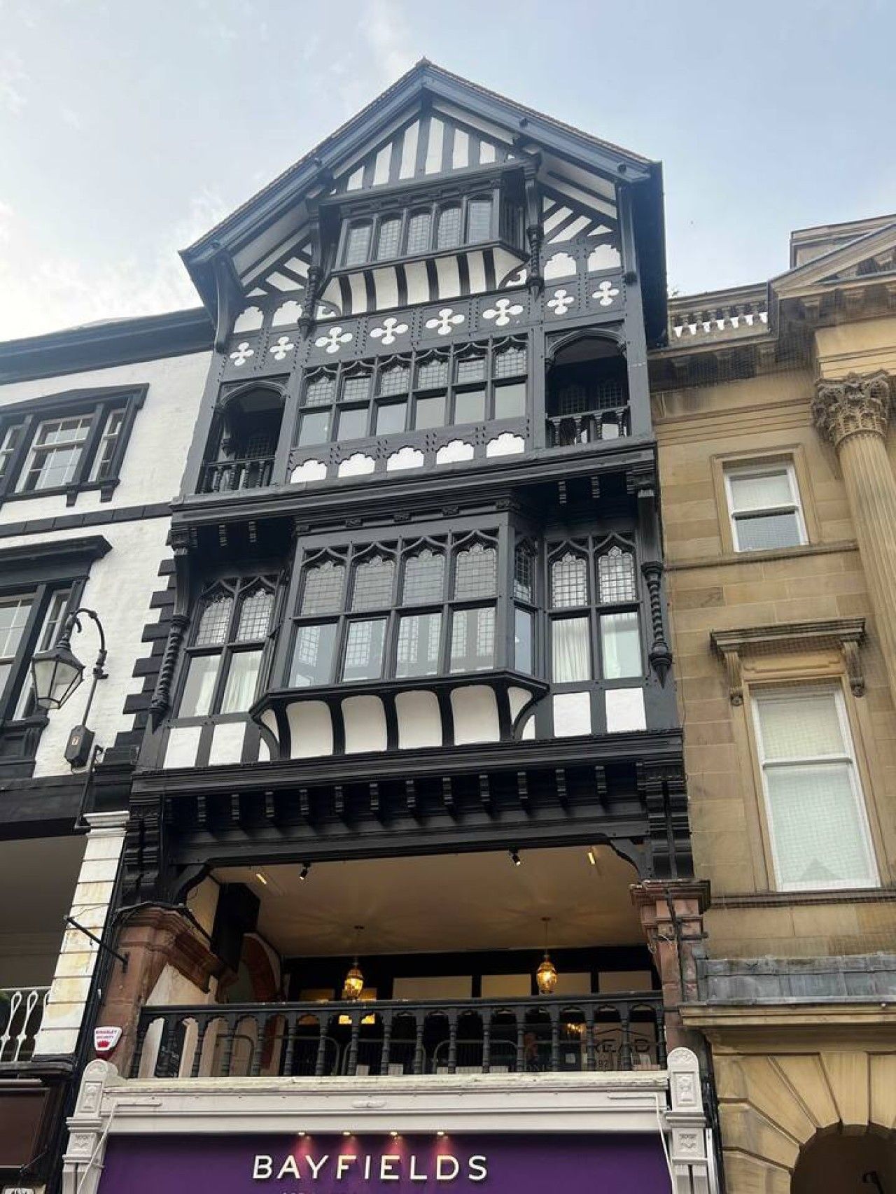 A building with a bay window, a balcony, and a sign reading 'BAYFIELDS'.