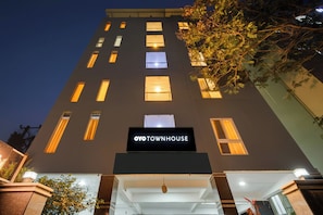 A multi-story building with a sign reading 'OYO TOWNHOUSE' at the entrance. - OYO VIBEHAUS (Hyderabad)