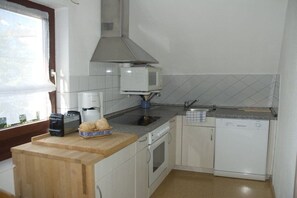 Eine kleine Küche mit Mikrowelle, Toaster und kleinem Backofen.