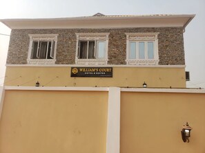 A hotel named 'William's Court' with a stone facade and a sign above the entrance.