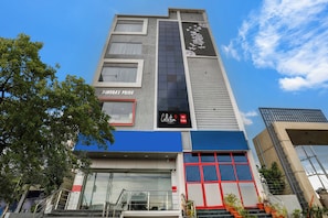 A hotel building with a prominent sign reading 'CHANDRA'S PRIDE' and a smaller sign for 'Hotel De Alpha Collection.' - Collection O De Alphabet Hotel (Hyderabad)