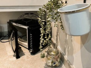 A kitchen with a black appliance, a white container, and a glass jar with a plant. - Mathew Street CITY - City 1 BDR apt sleeps 6 (Merseyside)