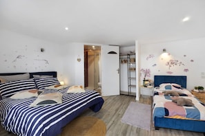 A modern bedroom with two beds, a shower area, and a small bathroom. - Bed and Breakfast 'Chambre 4' with Shared Terrace, Wi-Fi and Air Conditioning (Saint-Gervais)