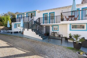 A two-story building with a staircase, outdoor seating, and potted plants. - Bed and Breakfast 'Chambre 2' with Shared Terrace, Wi-Fi and Air Conditioning (Saint-Gervais)