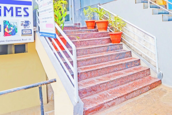 A set of outdoor stairs with handrails, leading to a building entrance. - Collection O De Alphabet Hotel UMCC (Hyderabad)