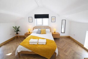 A bedroom with a bed, bedside tables, a window, and a potted plant. - Myrtle Cottage-Hot tub. Sky TV. Relaxing. Romantic. Couples (Carlisle)