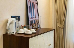 A hotel room with a coffee station, a framed picture on the wall, and a curtain. - Kudat Golf and Marina Resort (Kudat)