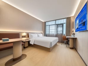A modern hotel room with a bed, bedside table, lamp, desk, chair, and a large window with curtains. - Hanting Hotel Xihu Xiebai (Hangzhou)