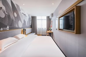 A hotel room with a large bed, a desk, a television, and a mural on the wall. - Thank Inn Plus Hotel Shanghai Songjiang District Yexie Town Yexingong Road (Shanghai)