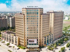 A high-rise building with multiple floors, large windows, and a prominent entrance. - Xiangxie Lidu Hotel (Taizhou)