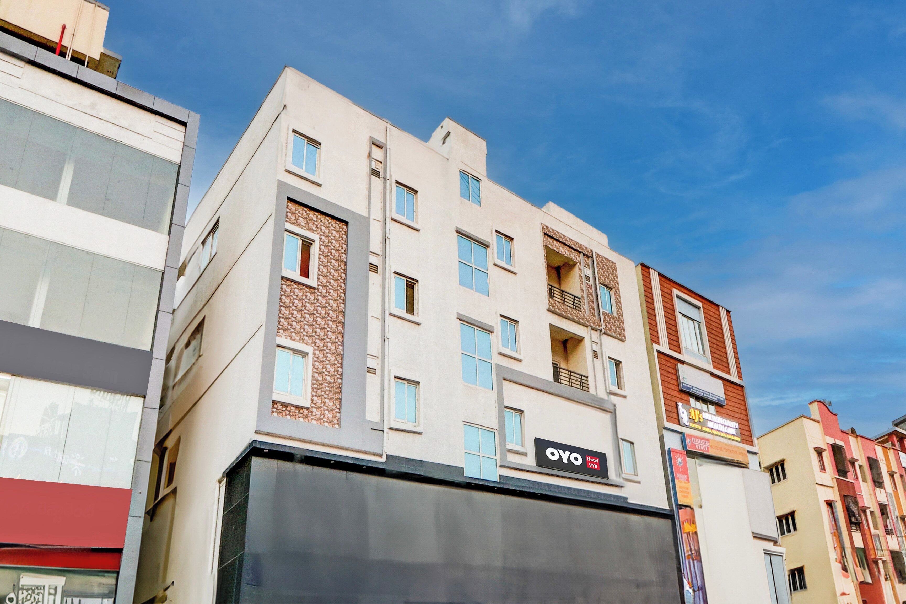 A multi-story hotel with a modern facade, balconies, and a prominent hotel sign.