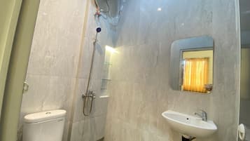 Ein Badezimmer mit Toilette, Dusche und Waschbecken.