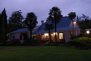 A house with a sloped roof, a front porch, and a well-maintained lawn. - Haggards on Hilldrop (Newcastle)