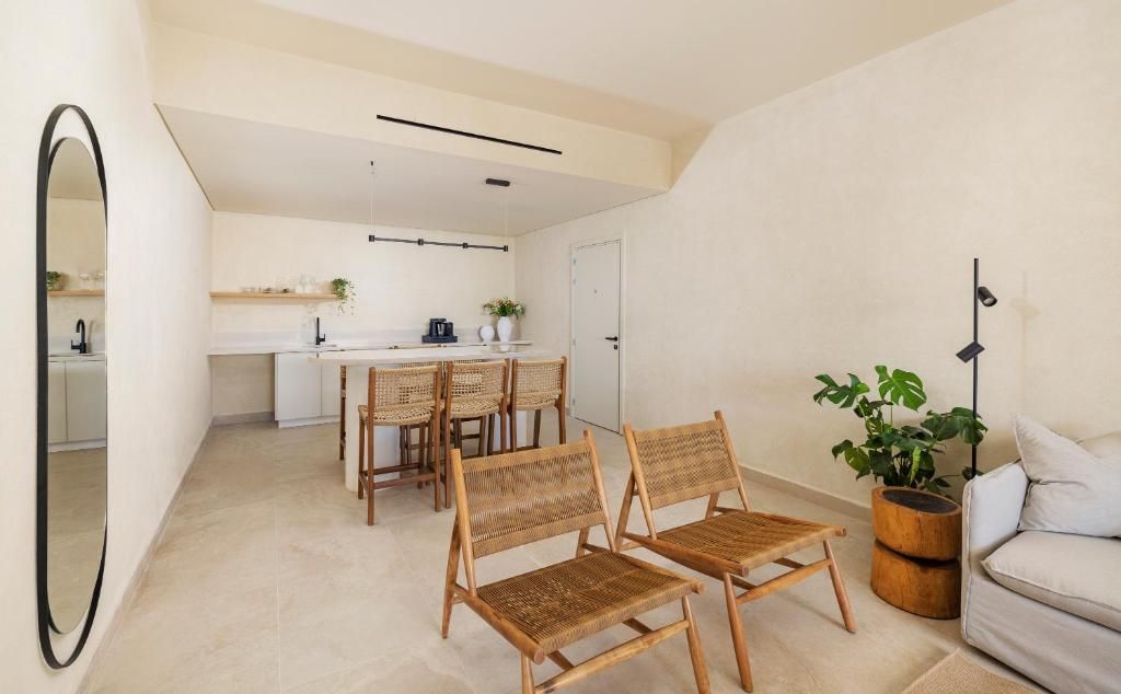 A modern interior with a dining area, kitchen, and seating space.
