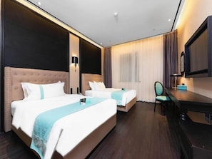 A hotel room with two beds, a desk, a chair, a television, and a large window with curtains. - Xana Hotelle (Guangzhou)