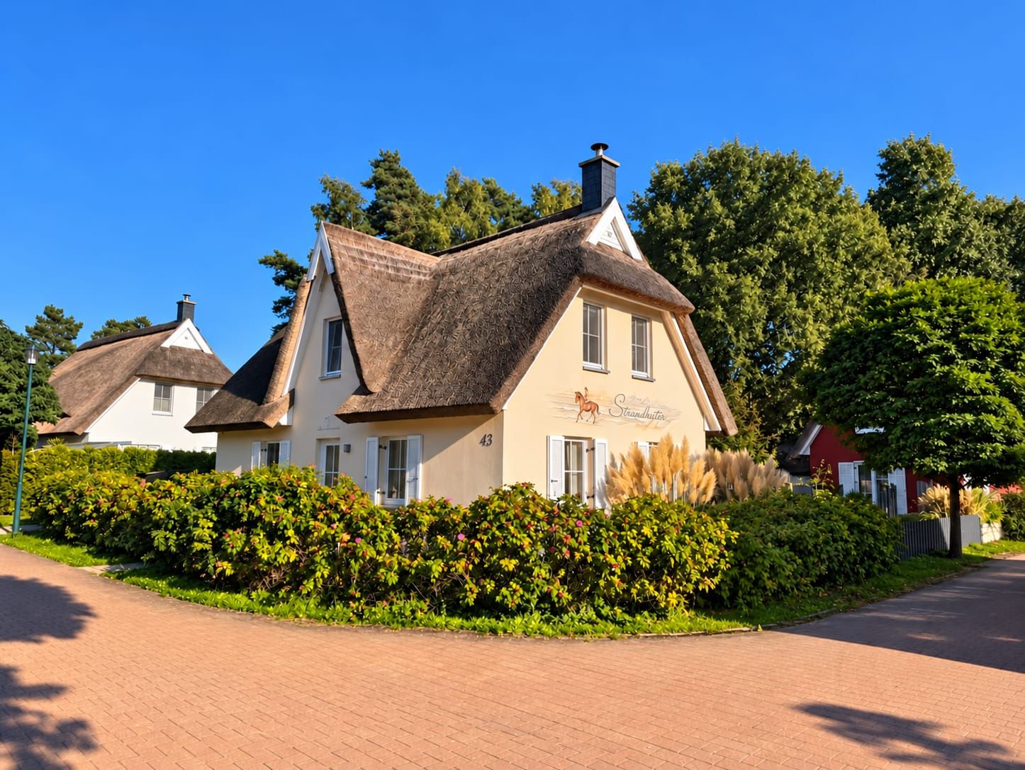 A traditional building with a thatched roof, a sign indicating it is a guesthouse, and a number 43.