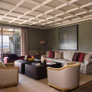 A modern living room with a sofa, armchairs, a coffee table, and a staircase leading to an outdoor area. - Collegio Alla Querce, Auberge Resorts Collection (Florence)