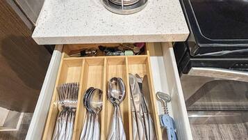 A kitchen drawer with utensils neatly organized.