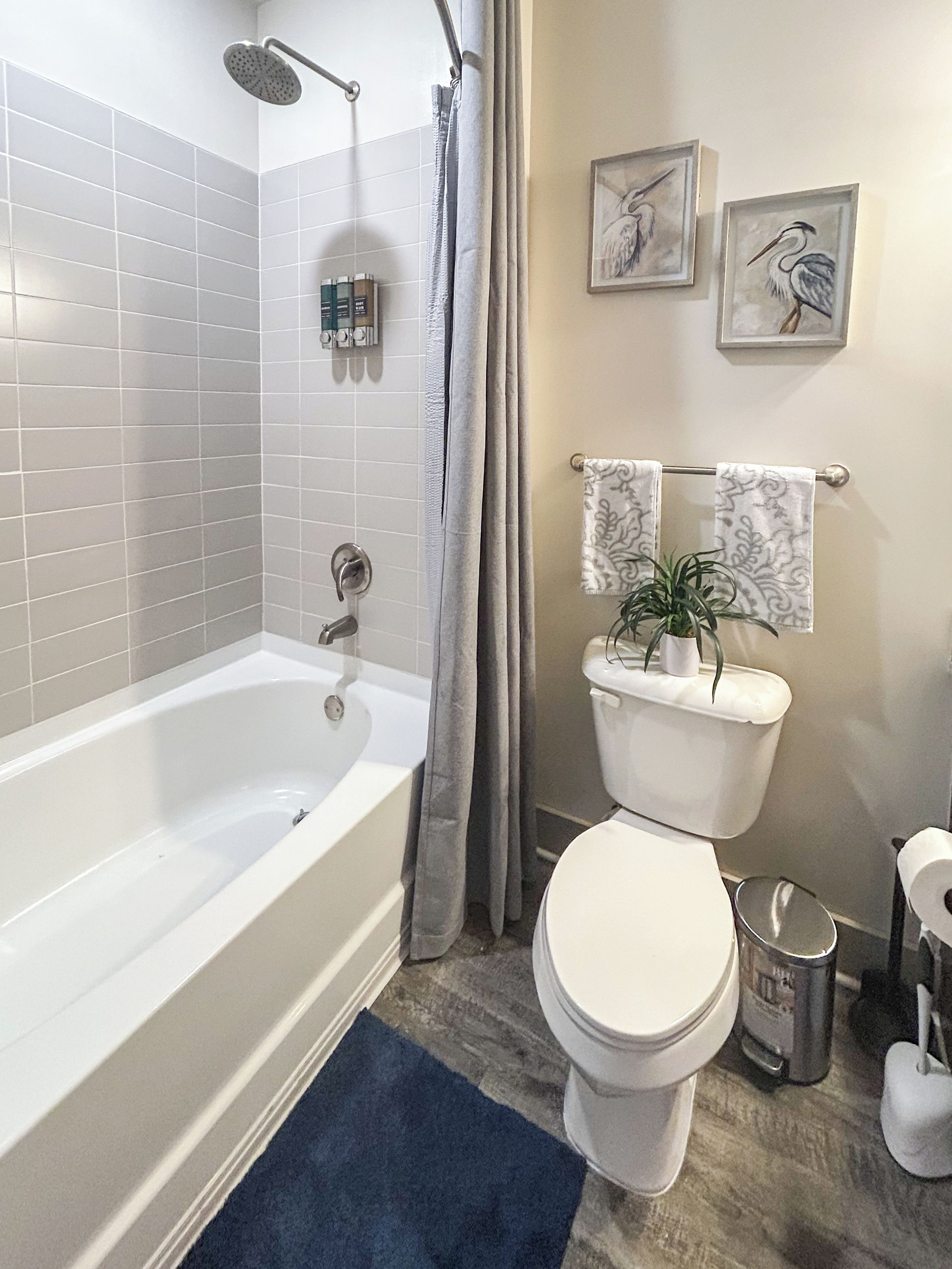 A bathroom with a bathtub, toilet, and shower.