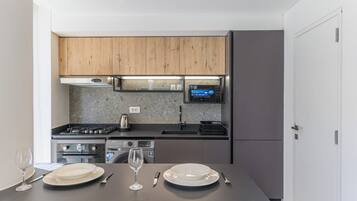 A modern kitchen with wooden cabinets, a gas stove, and a built-in oven.