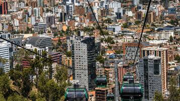 A cityscape with multiple high-rise buildings and a cable car system.