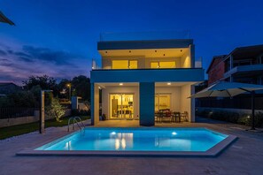 A modern two-story house with a swimming pool in the foreground. - Villa Mate With Pool and Beautiful sea View (Krk)