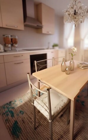 A dining area with a wooden table and chairs, a chandelier, and a rug. - Aura Luxury Apartment: Sleeps 7, Garden, Parking, Near St. Peter's & Metro (Roma)