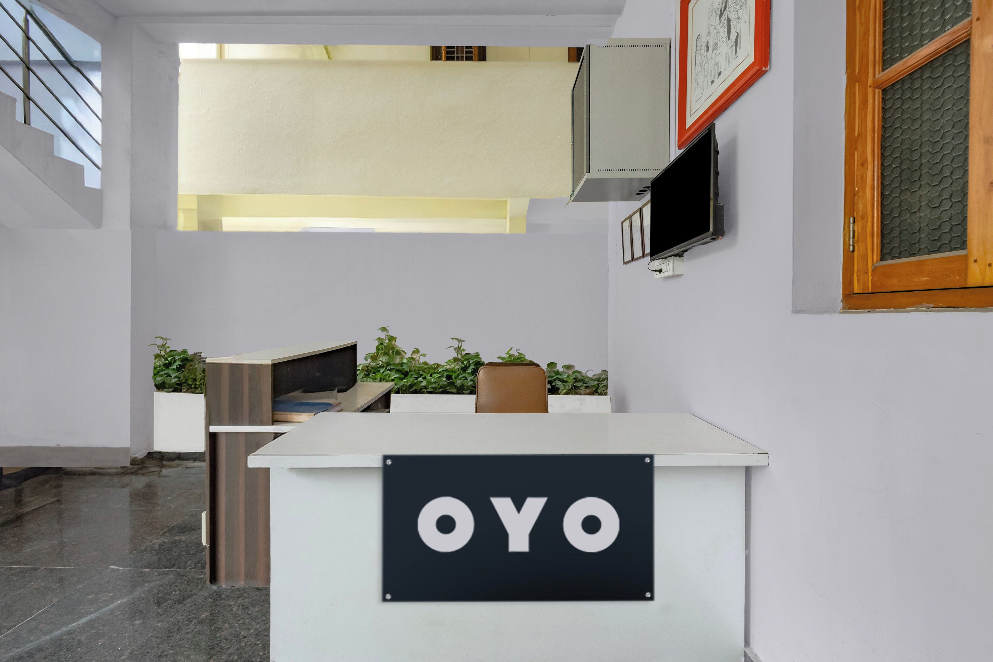 A reception desk with a sign that reads 'OYO'.