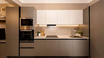 A modern kitchen with built-in appliances, a central island, and a minimalist design.