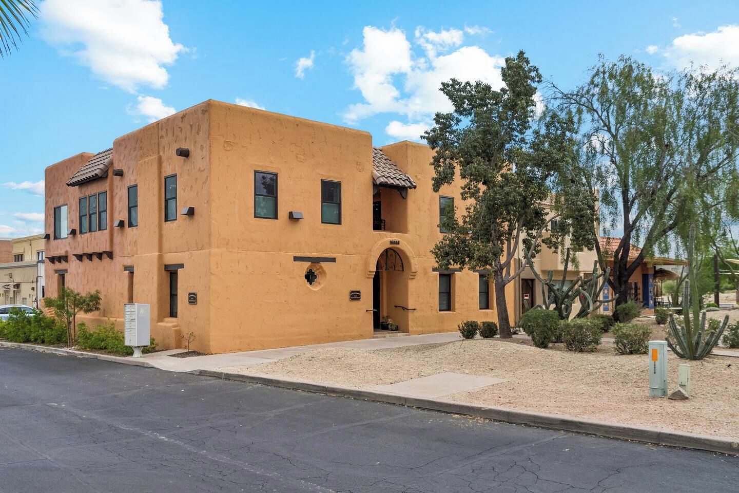 A building with a flat roof, multiple windows, and a small entrance.
