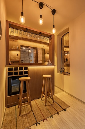 A kitchen with a wooden countertop, two stools, and hanging light fixtures. - 3-Storey Private Townhouse with Sauna,Bar,Terrace, 3BR,3BA (Beyoğlu)