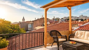 A rooftop terrace with a wooden pergola, wicker furniture, and a view of the cityscape. - 3-Storey Private Townhouse with Sauna,Bar,Terrace, 3BR,3BA (Beyoğlu)